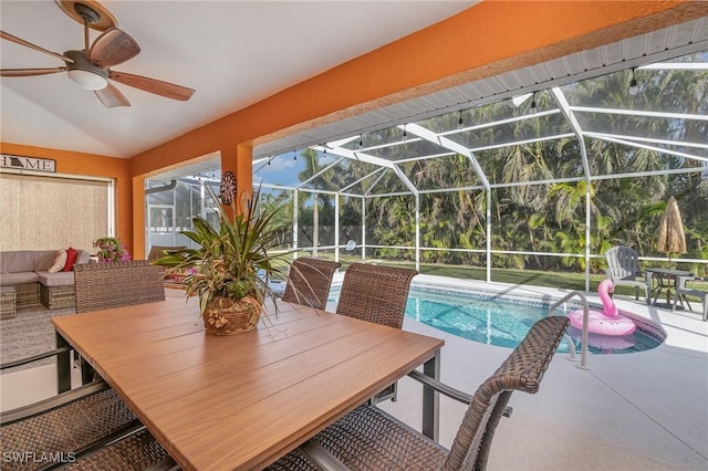 view of pool with a lanai, a patio area, and ceiling fan