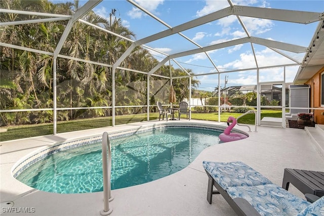 view of pool with glass enclosure, a yard, and a patio