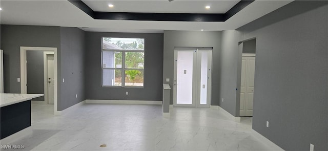 foyer entrance with a tray ceiling