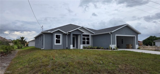 view of front of home with a front lawn and a garage