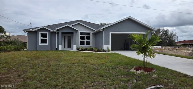 view of front of property with a garage and a front lawn