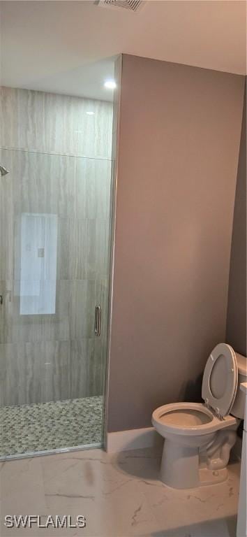 bathroom with toilet and a shower with door