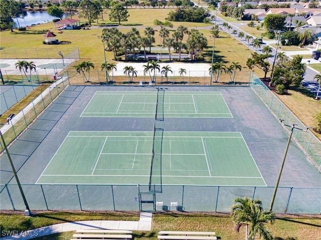 view of sport court with a water view