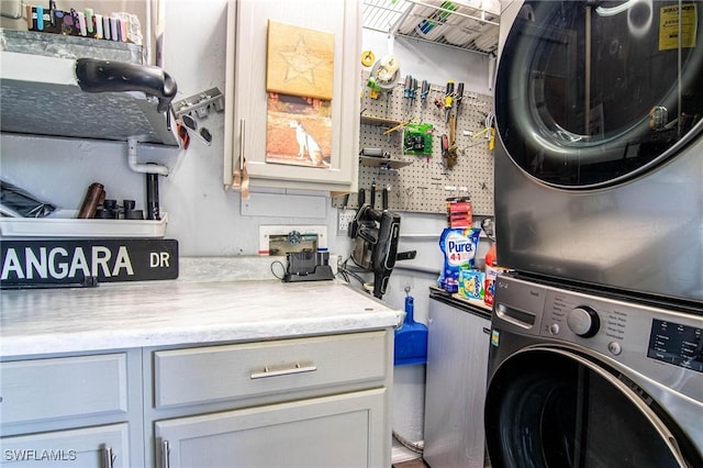 clothes washing area featuring stacked washer / dryer