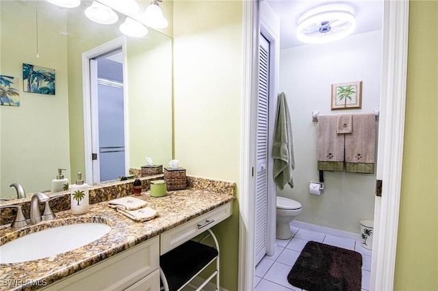 bathroom featuring tile patterned floors, vanity, and toilet