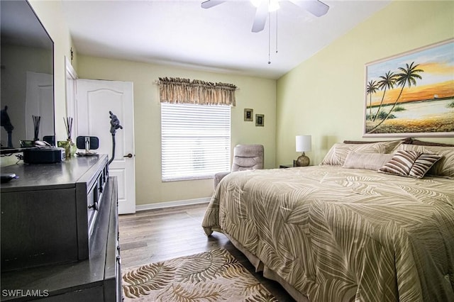 bedroom with light hardwood / wood-style flooring, ceiling fan, and lofted ceiling