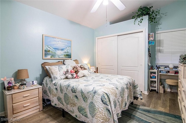 bedroom with ceiling fan, vaulted ceiling, dark wood-type flooring, and a closet