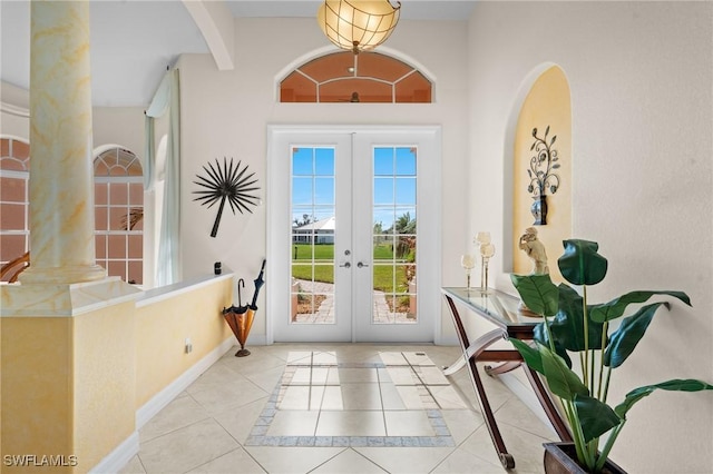 doorway to outside with french doors and light tile patterned floors