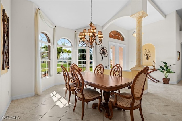 dining space with light tile patterned floors, an inviting chandelier, ornate columns, and french doors