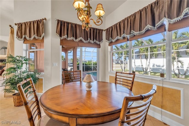 dining space featuring light tile patterned flooring and a chandelier