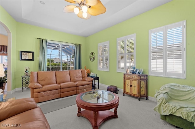 carpeted living room with plenty of natural light and ceiling fan