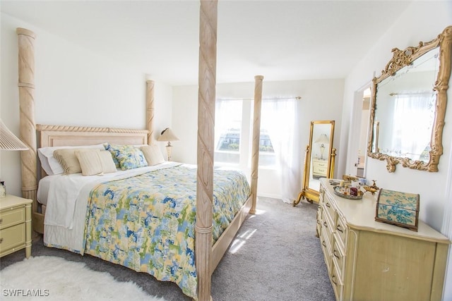 carpeted bedroom featuring multiple windows