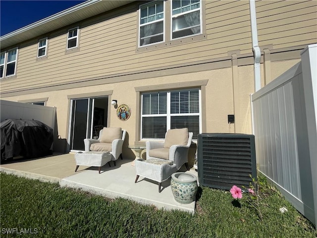 rear view of house featuring central AC unit