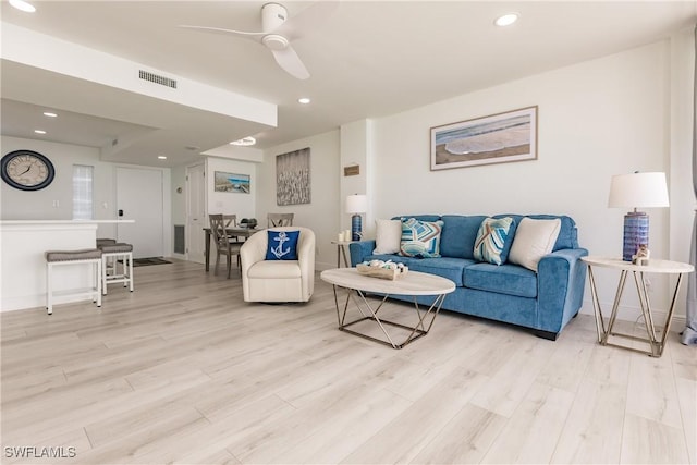 living room with ceiling fan and light wood-type flooring