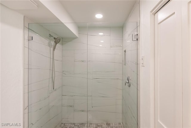 bathroom with a shower with shower door