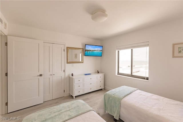 bedroom featuring a closet and light hardwood / wood-style flooring