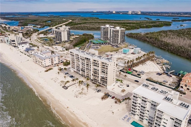 birds eye view of property featuring a water view and a beach view