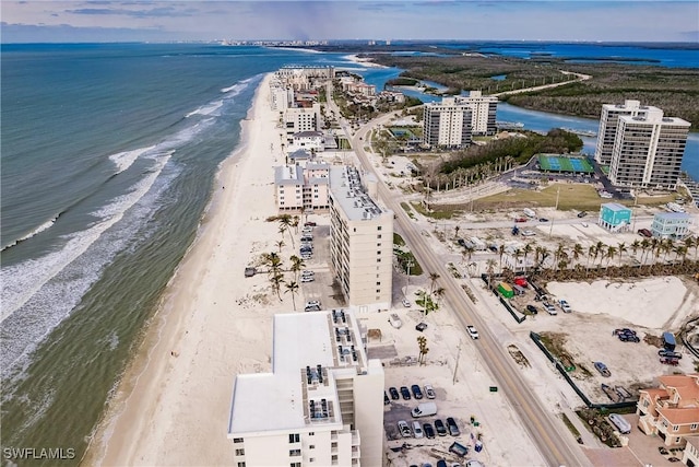 birds eye view of property featuring a water view and a beach view