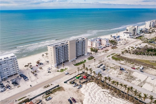 drone / aerial view featuring a water view and a beach view