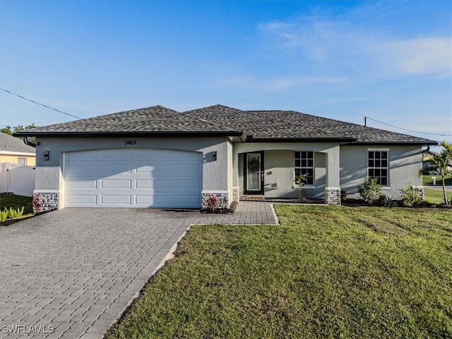 single story home featuring a front lawn and a garage