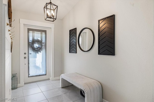 tiled entrance foyer with a chandelier