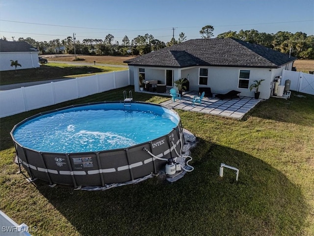 view of pool featuring a lawn and a patio area