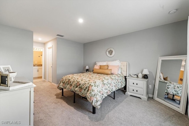 carpeted bedroom featuring ensuite bathroom