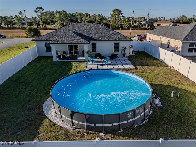 view of swimming pool featuring a lawn and a patio