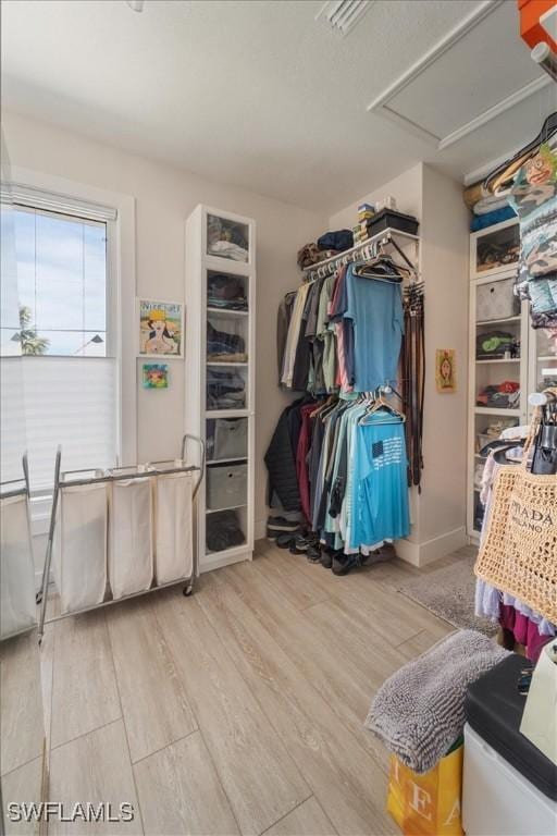 spacious closet with light hardwood / wood-style floors