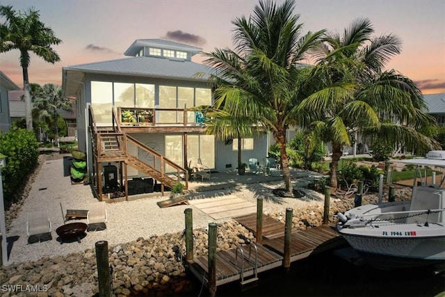 back house at dusk with a patio area