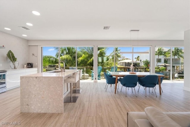 interior space featuring recessed lighting, light wood finished floors, and visible vents