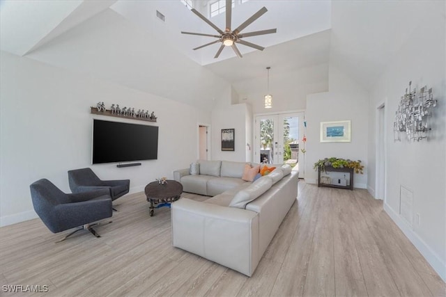 living room featuring high vaulted ceiling, french doors, a ceiling fan, baseboards, and light wood-type flooring