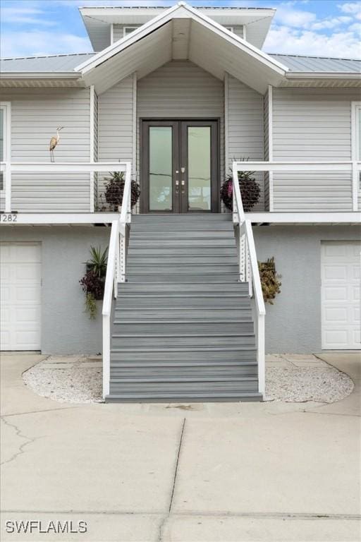 view of exterior entry featuring french doors