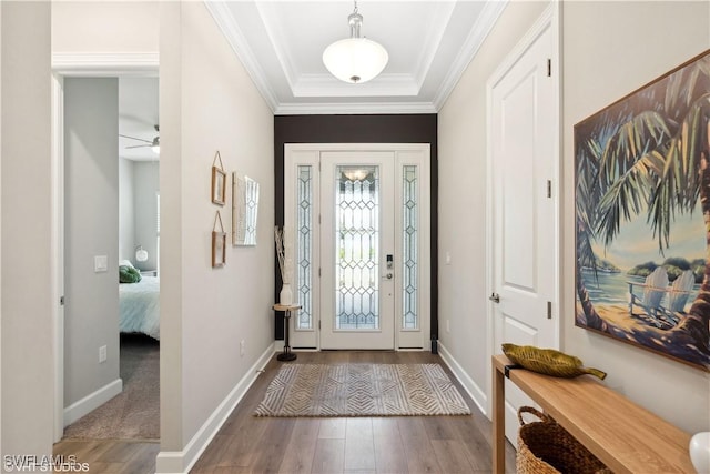 foyer with hardwood / wood-style floors, ceiling fan, and ornamental molding