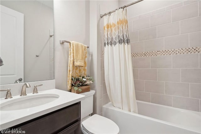 full bathroom featuring vanity, shower / bathtub combination with curtain, and toilet