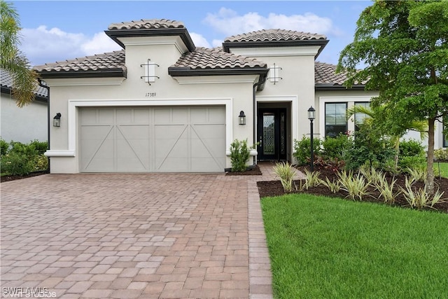 mediterranean / spanish-style home with a front yard and a garage