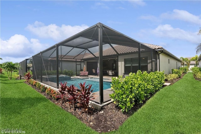 view of swimming pool featuring glass enclosure, a yard, and an in ground hot tub