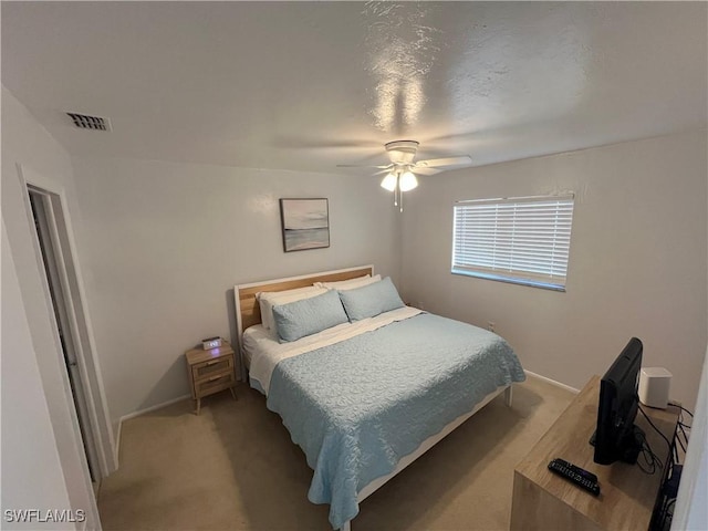 bedroom with ceiling fan and carpet floors