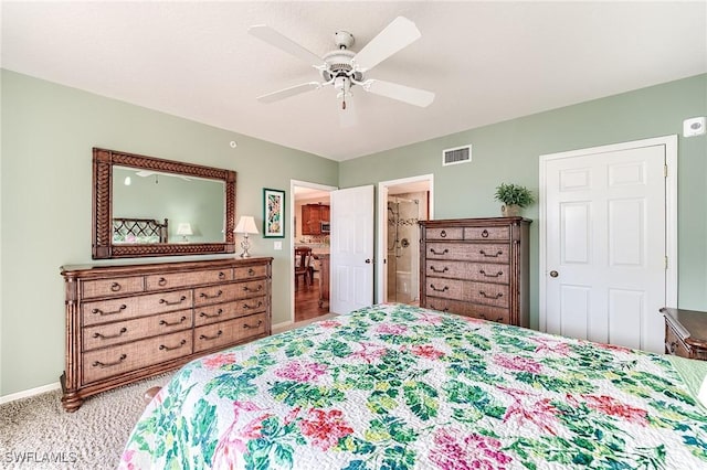 bedroom with visible vents, light carpet, connected bathroom, ceiling fan, and baseboards