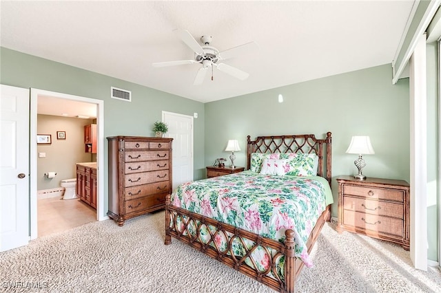 bedroom with light carpet, ceiling fan, connected bathroom, and visible vents