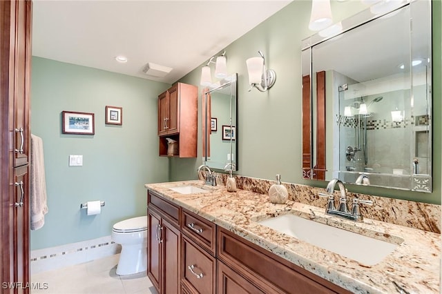 bathroom featuring double vanity, a sink, toilet, and an enclosed shower