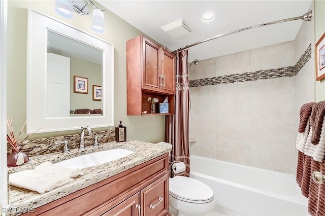 bathroom featuring visible vents, shower / tub combo with curtain, vanity, and toilet