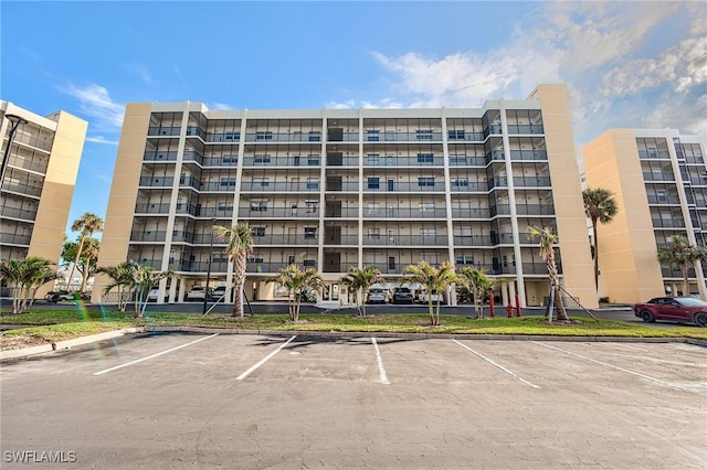 view of building exterior featuring uncovered parking