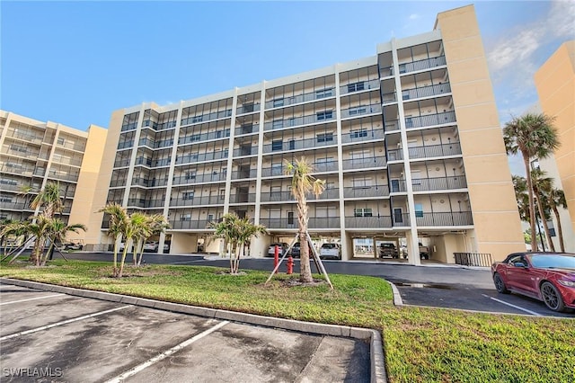 view of building exterior featuring uncovered parking