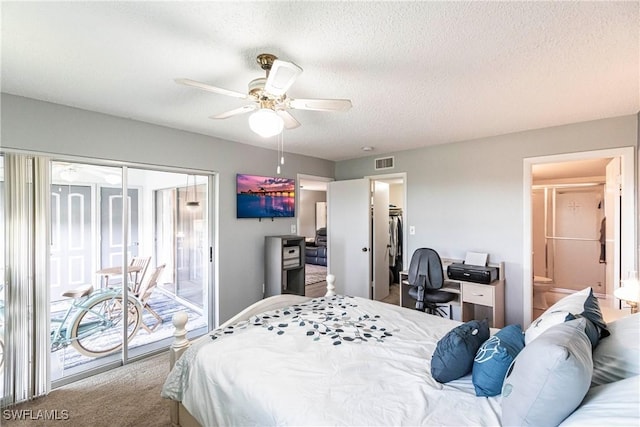 bedroom with connected bathroom, access to exterior, ceiling fan, and a textured ceiling