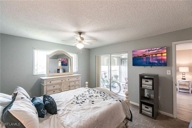 carpeted bedroom featuring ceiling fan and a textured ceiling