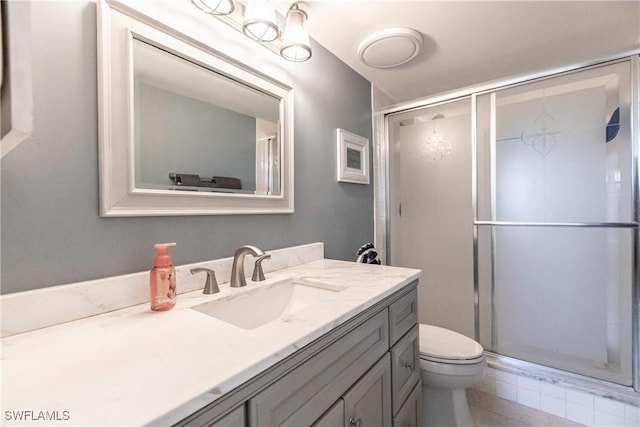 bathroom featuring vanity, toilet, and walk in shower