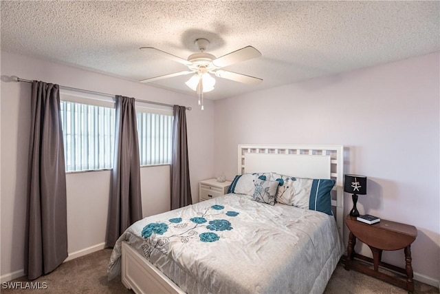 carpeted bedroom featuring ceiling fan and a textured ceiling