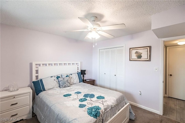 carpeted bedroom with a textured ceiling, a closet, and ceiling fan