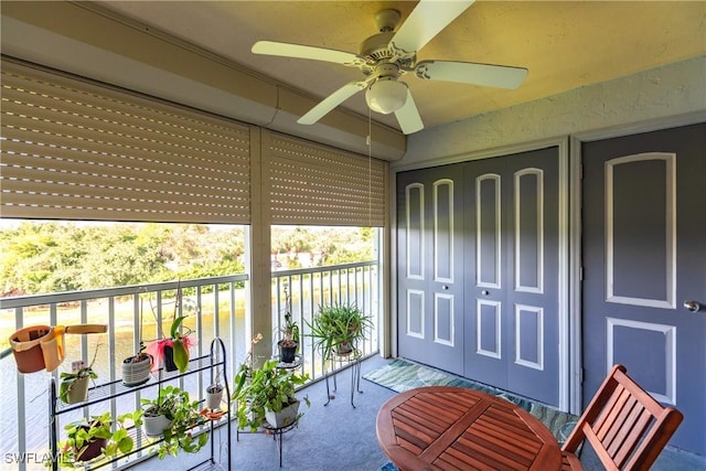 sunroom / solarium featuring ceiling fan